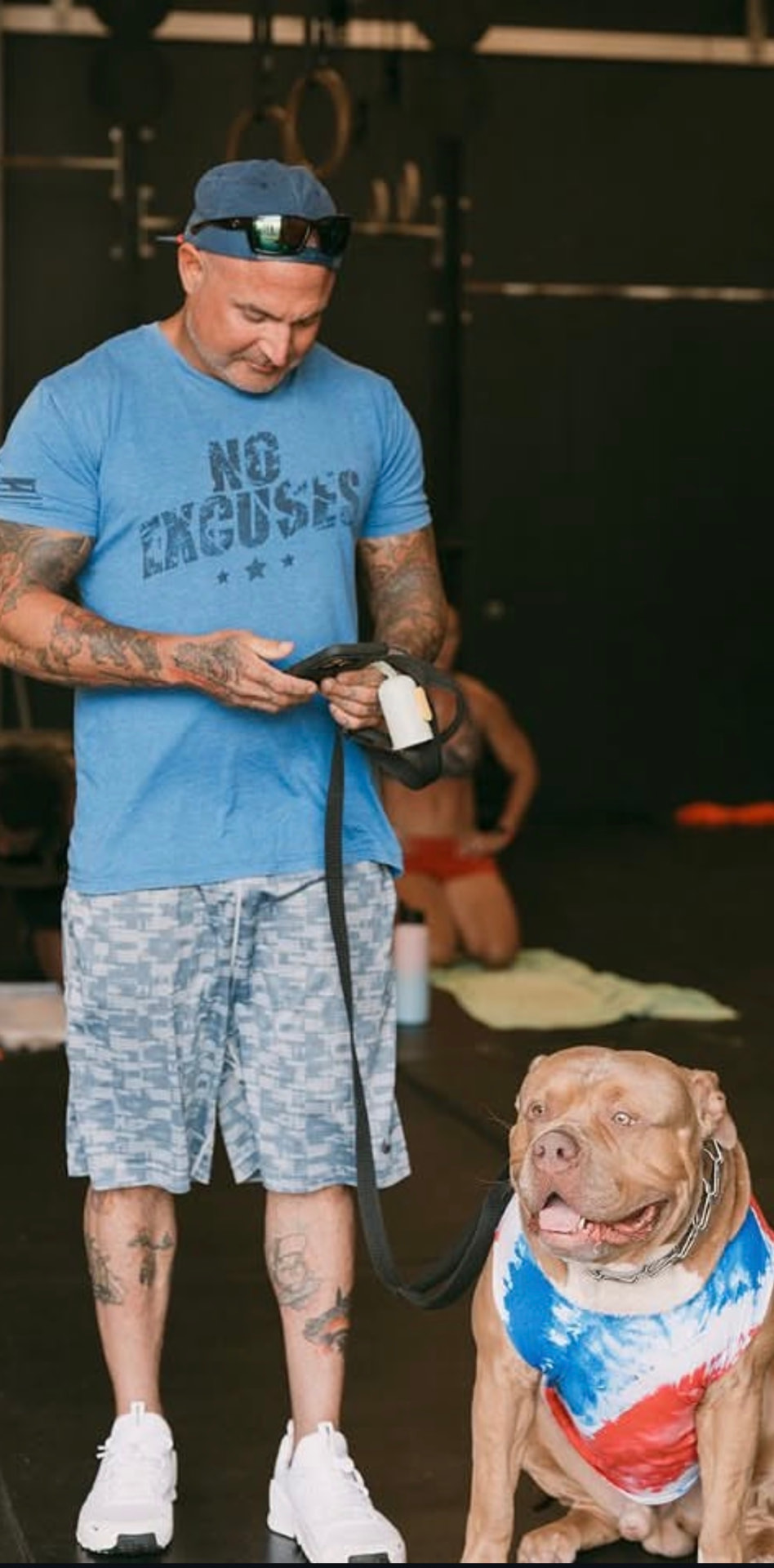 Jeff Beck standing with his dog Milo in a gym